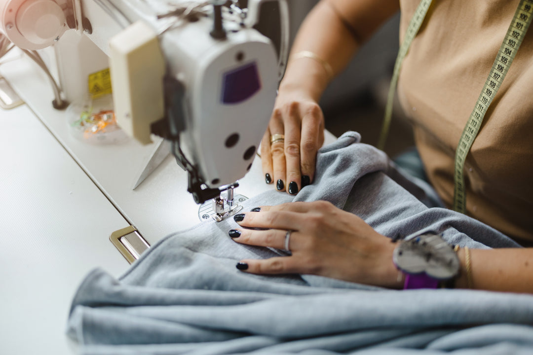 Inspirational Sewing Moment: Close-Up of Hands Skillfully Guiding Fabric Through a Sewing Machine